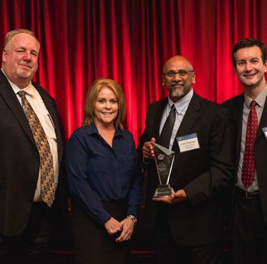 Jim Willman (far left), manager of procurement and contracts for Bechtel Corporation, and Kelly Miller, supply chain management department head at Lawrence Livermore National Laboratories, present the 2014 Bechtel Award for Large Subcontractor of the Year to Lasertel Vice President of Engineering Prabhu Thiagarajan and President Mark McElhinney.